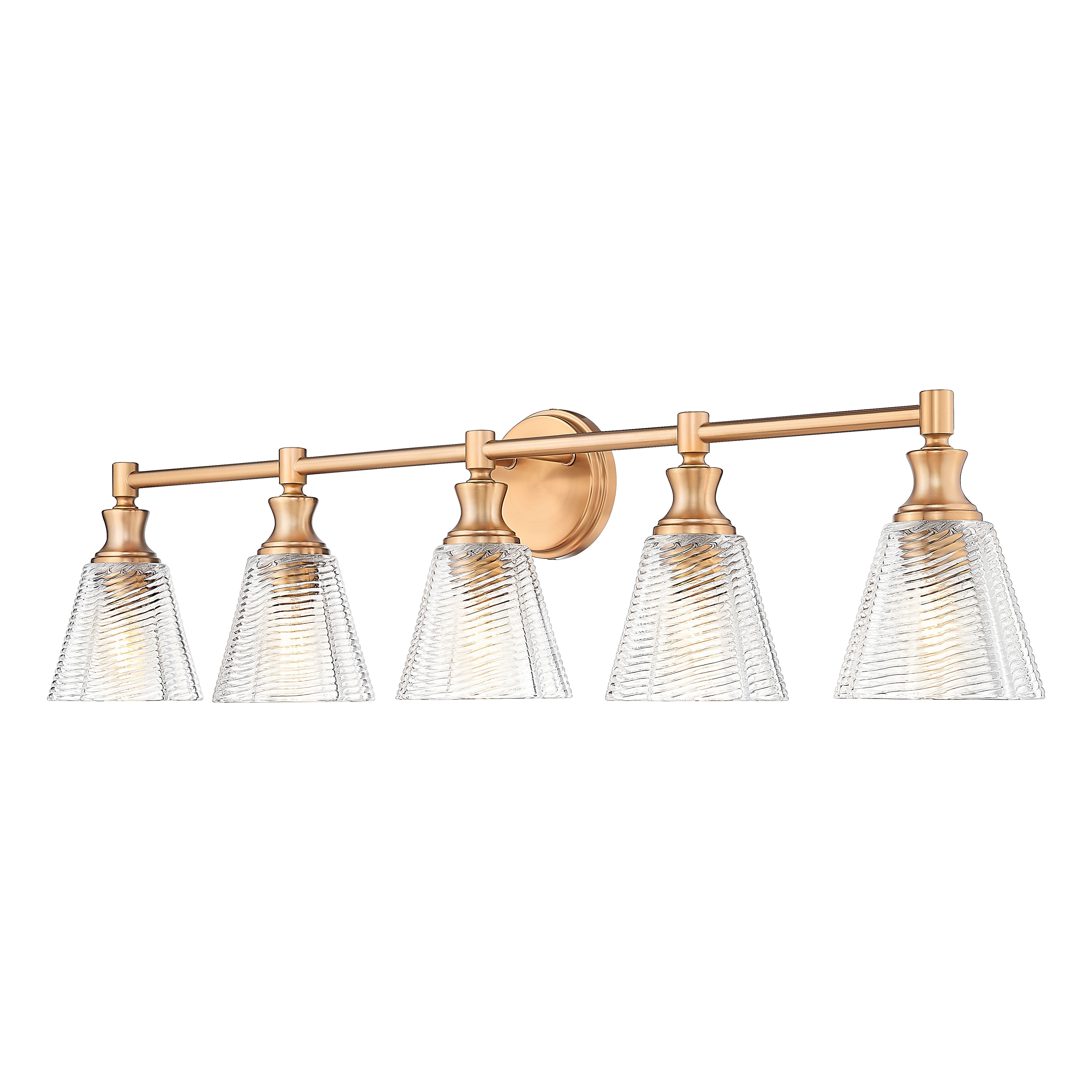A 4-light bathroom vanity light fixture with a warm brushed brass or gold-finished metal bar and matching wall mount, featuring four clear ribbed glass shades.