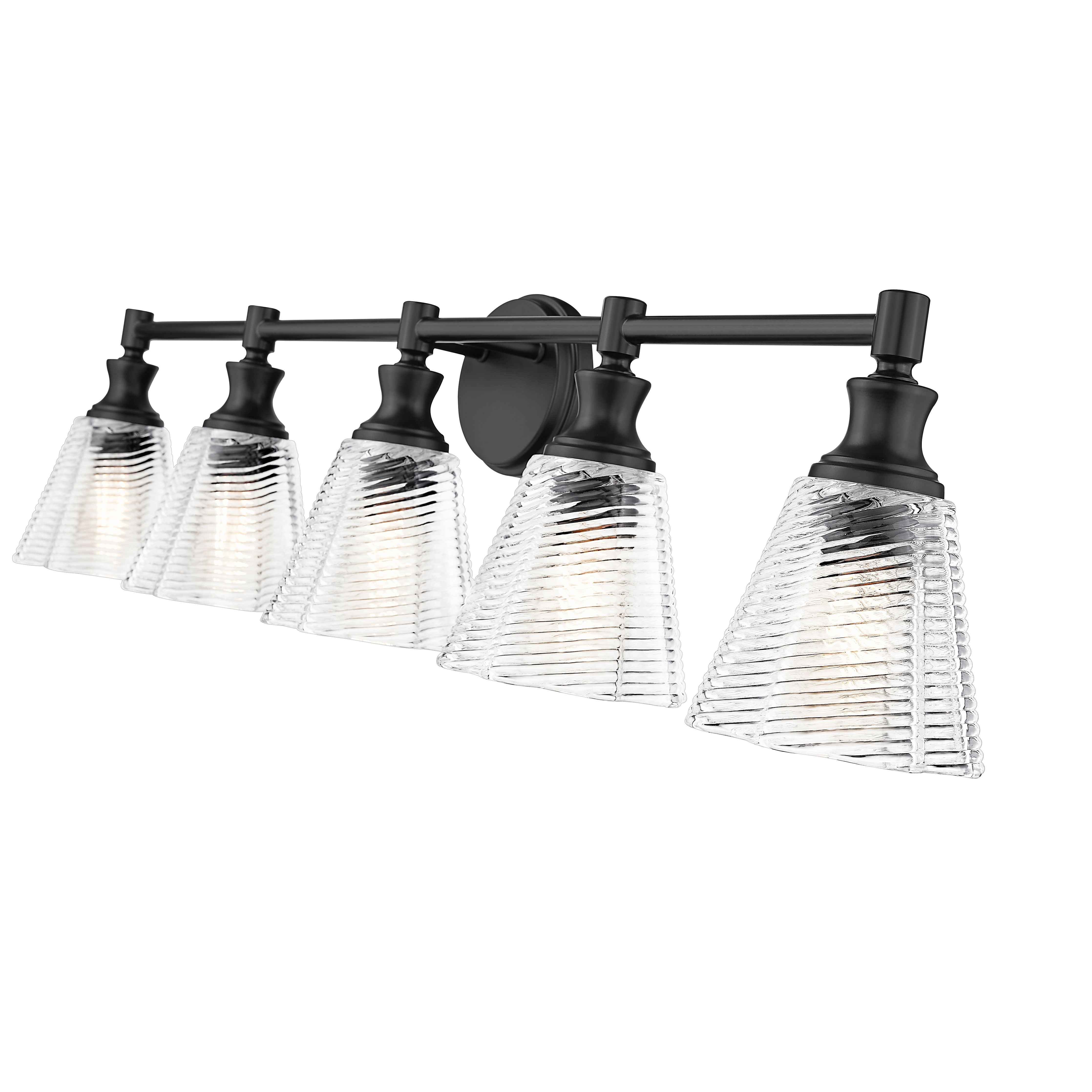 A five-light bathroom vanity light fixture with a matte black horizontal bar and wall mount, featuring clear ribbed glass shades that glow with warm light, shown against a plain white background.