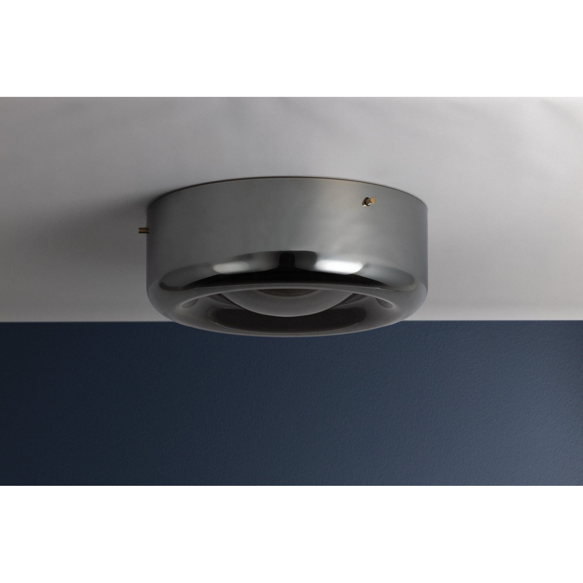 Gunmetal grey round flush mount ceiling light installed on ceiling in styled room