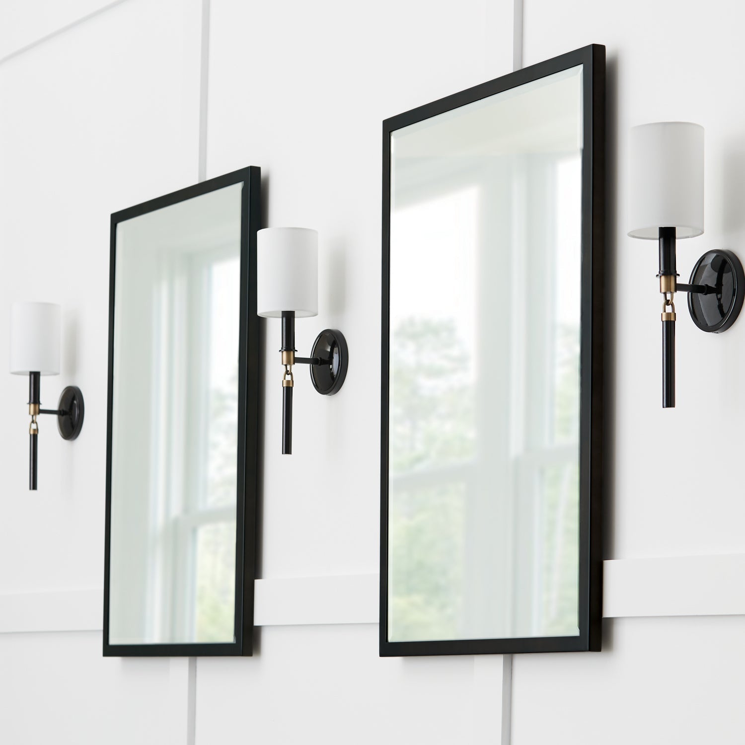 A stylish modern black and white wall sconce design, perfect for adding contemporary lighting to any room with a welcoming atmosphere.