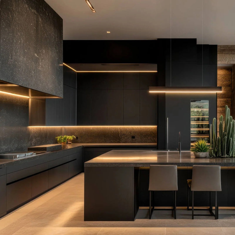 Modern black kitchen with warm LED strip lighting under cabinets, along the island, and above the backsplash.