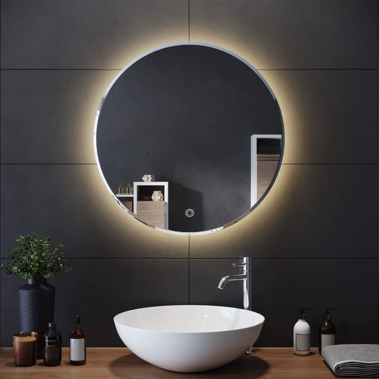 Round LED mirror with lights above a bathroom vanity; modern lighted bathroom mirror design.