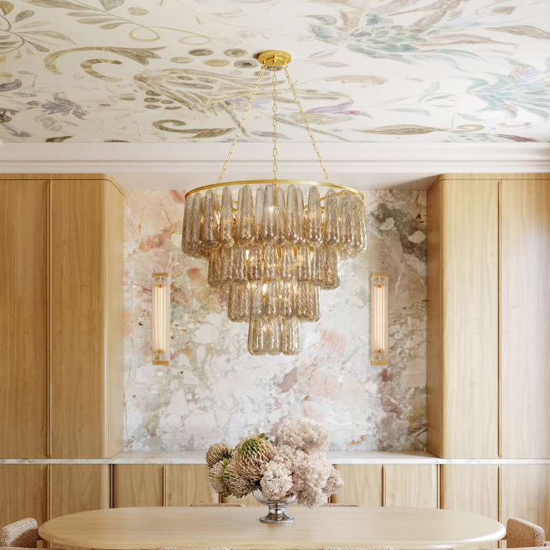 Tiered amber glass chandelier above a light wood dining table in an elegant dining room.
