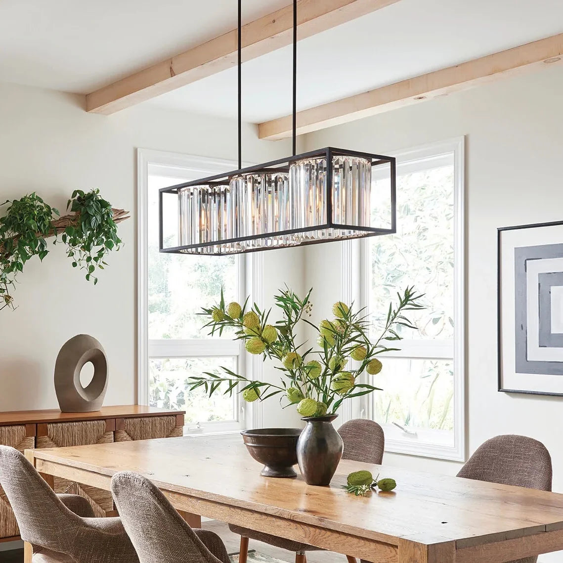 Sale ceiling light with rectangular crystal panels hanging above a wooden dining table in a bright modern room.