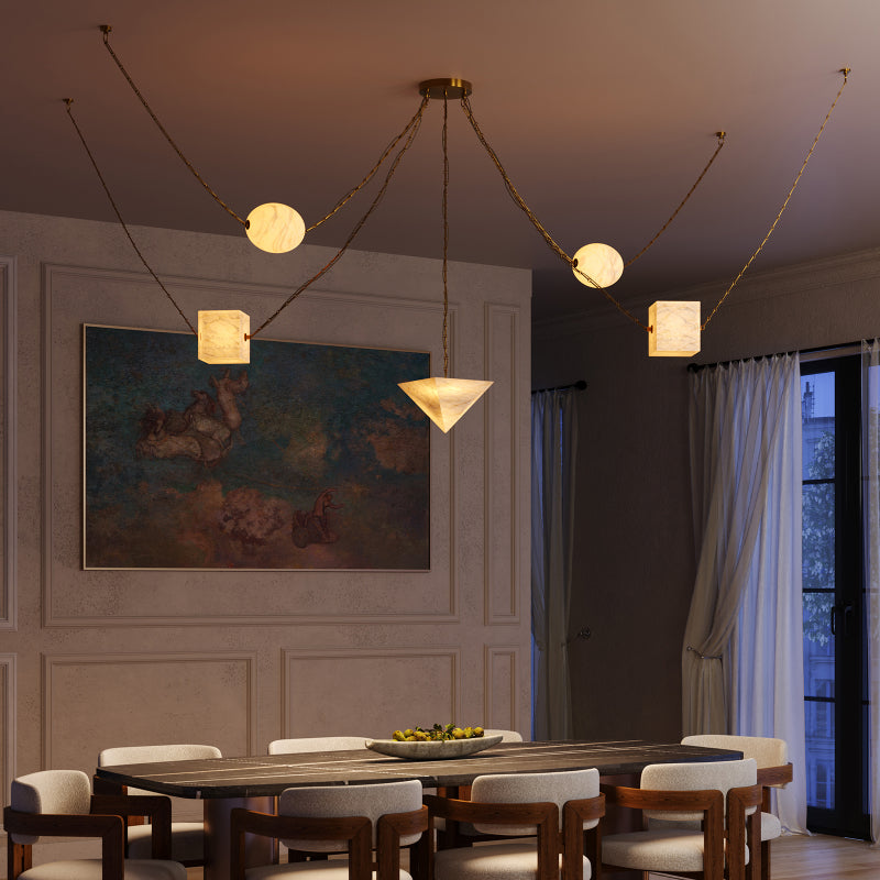 Alora multi-light chandelier with glowing sculptural shades and draped cords above a dining table.