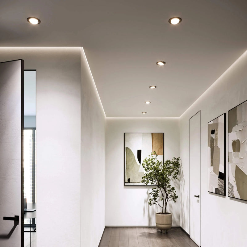 Recessed Trims recessed ceiling lights and cove lighting in a modern white hallway.