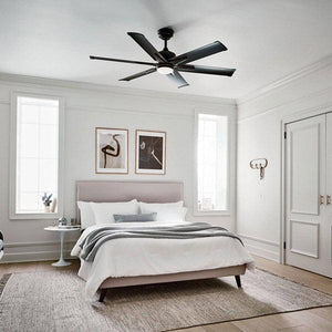 Modern black ceiling fan with an integrated light fixture installed in a bright, minimalist bedroom with white walls and soft decor.