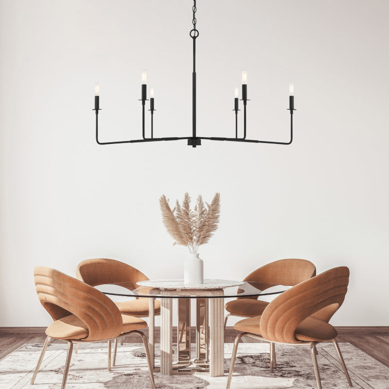 Black Chandeliers black candle-style chandelier hanging above a contemporary round dining table.