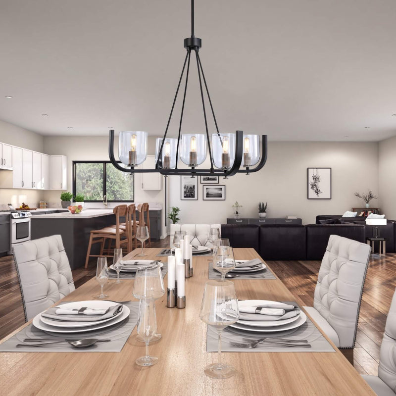 Candle Chandeliers black chandelier with clear glass shades above a formal dining table in an open living space.