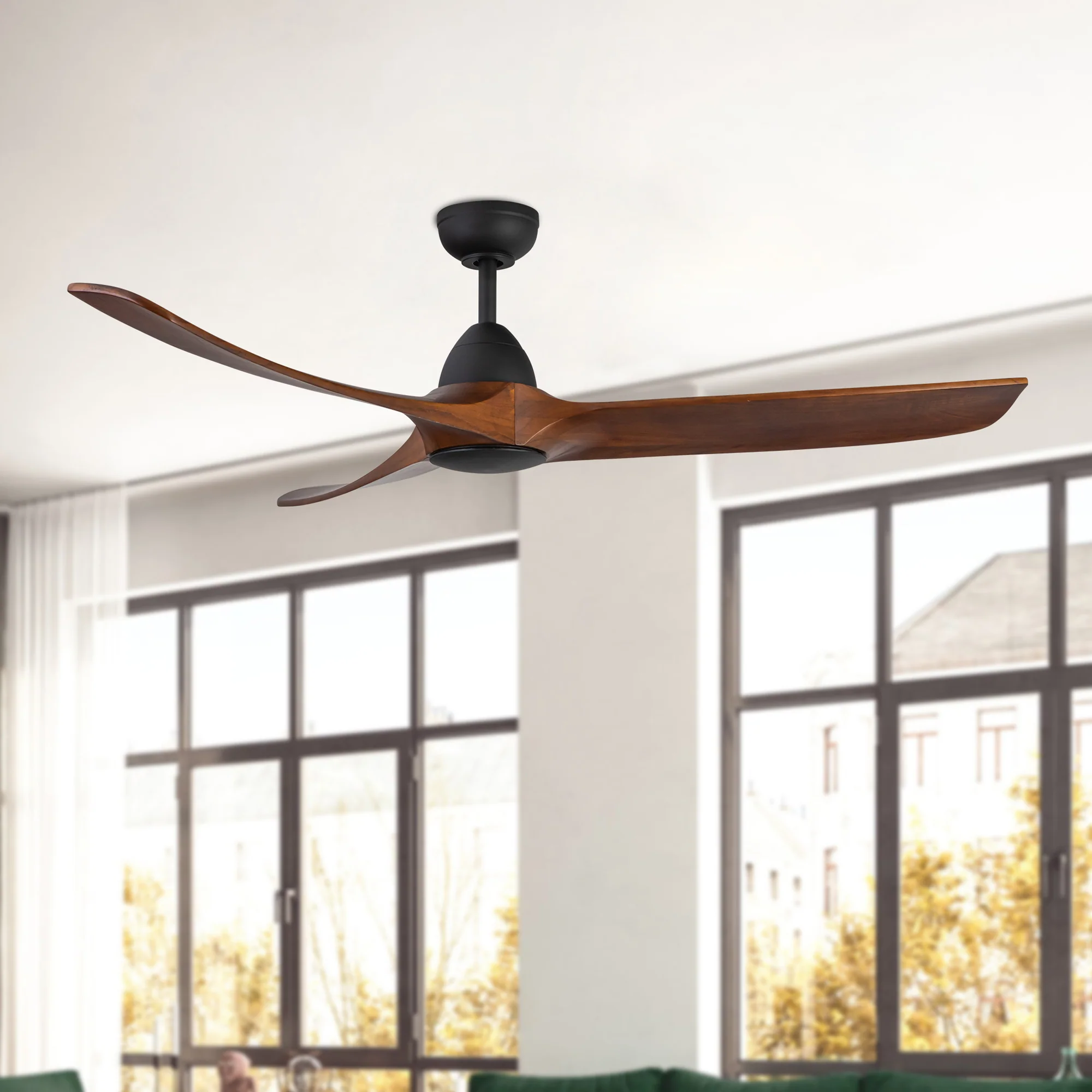 Ceiling Fans wood blade ceiling fan with black motor in a bright room with large windows.