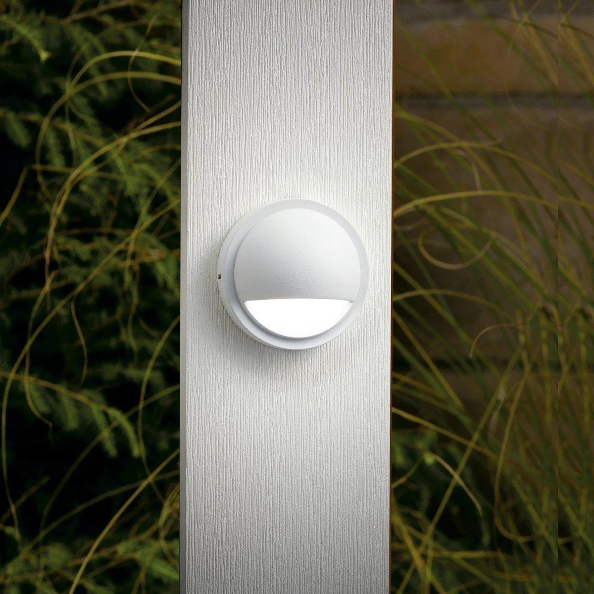 Deck Lights and Patio Lights white round deck light mounted on an outdoor post.