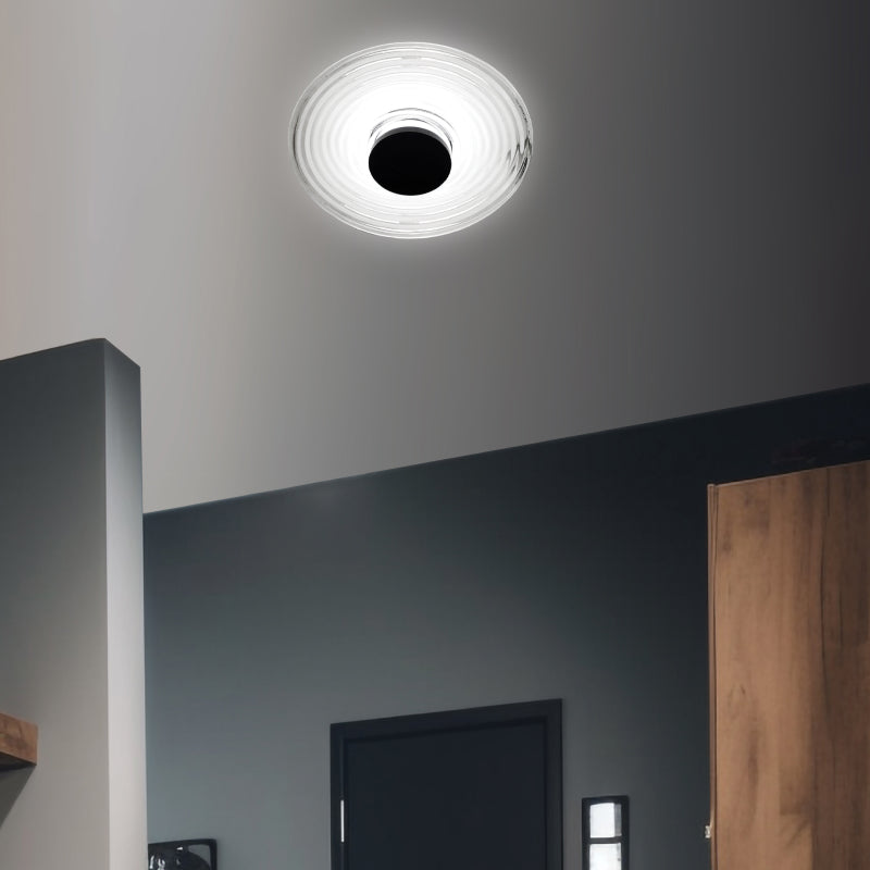 LED Flush Mount Lights modern LED flush mount light with clear circular diffuser on a dark ceiling.