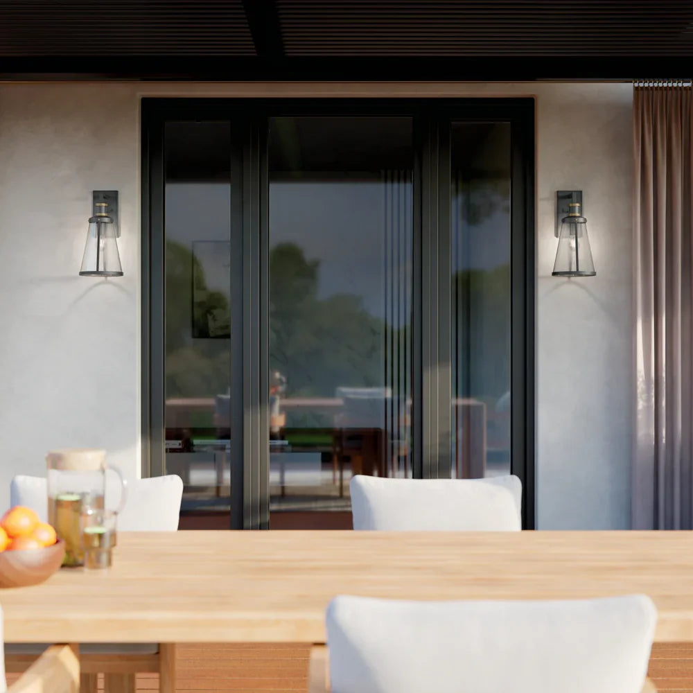 Sale outdoor lighting with two modern wall sconces mounted beside large patio doors in a contemporary outdoor dining space.