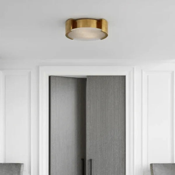 Flush mount lighting fixture from the Visual Comfort Signature Collection with a gold finish, installed in a modern room.