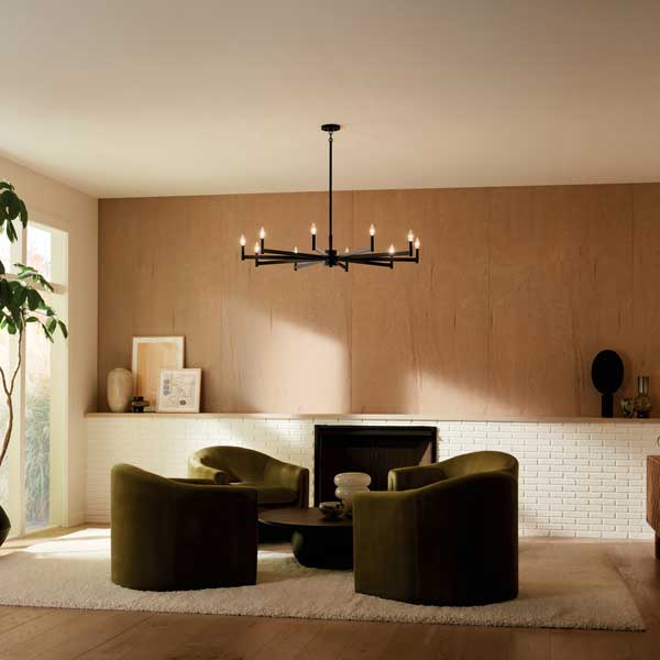 Modern black chandelier with candle-style bulbs in a warm minimalist living room