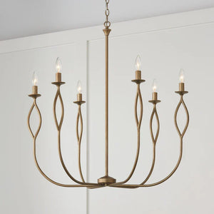 Candle chandelier with a gold frame and six candle-style lights, available at Lights Canada.