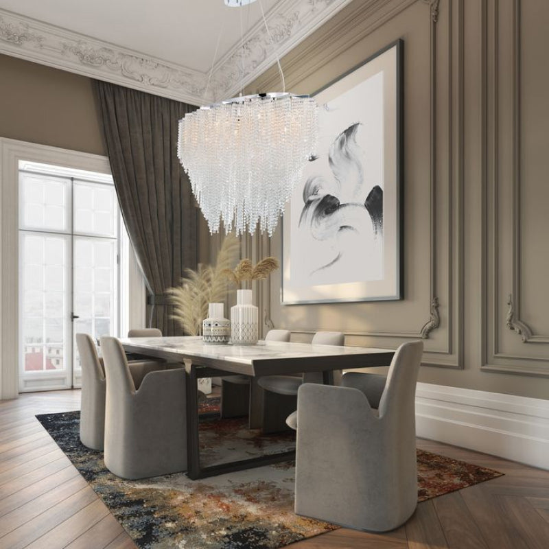 Crystal Chandeliers sparkling crystal chandelier above an elegant dining room with classic wall moulding.
