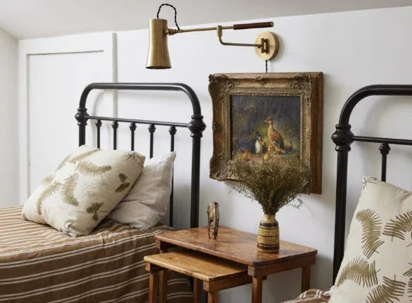 Cottagecore lighting with a vintage brass sconce, creating a cozy, nostalgic bedroom atmosphere.