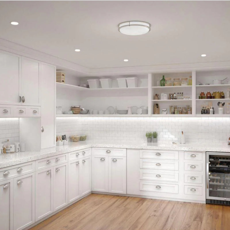 Recessed Housings recessed ceiling lights and flush mount fixture in a bright white kitchen.