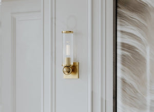 Everyday Luxe wall sconce with a sleek gold finish and ribbed glass shade, adding a touch of elegance to any space.