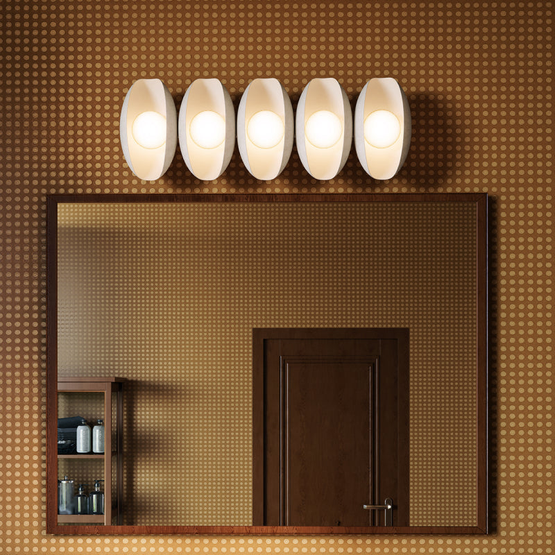 Vanity Lights modern vanity light with white oval shades above a bathroom mirror.