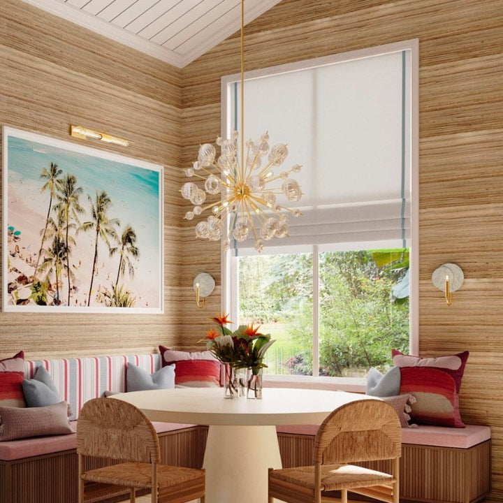 Dining area with a modern chandelier by Mitzi Lighting, featuring a brass and glass design, along with matching wall sconces for a bright, elegant space.