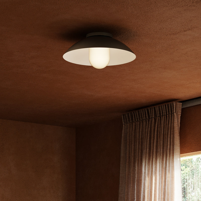 Flush & Semi Flush Mounts black and white flush mount ceiling light in a warm-toned room.