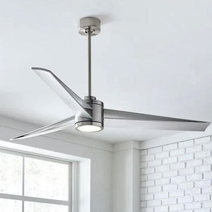 Sleek, modern large ceiling fan with three metallic blades and an integrated LED light fixture, mounted in a bright room with white brick walls.