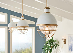 Coastal lighting featuring white and brass pendant lights with a nautical design, perfect for an airy, beach-inspired interior.