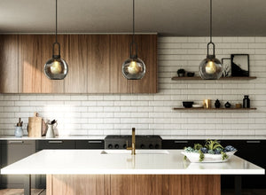 Contemporary and modern lighting featuring sleek glass pendants over a minimalist kitchen island, enhancing clean lines and modern design.