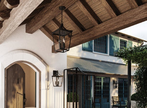 Craftsman and mission-style outdoor lighting with lantern fixtures, complementing the rustic wood beams and traditional architectural details.