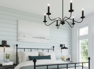 Farmhouse and rustic black iron chandelier in a bedroom with shiplap walls and modern decor