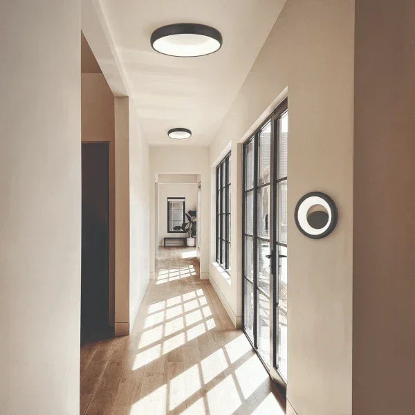 Modern hallway featuring flush mount ceiling lights by Matteo, providing sleek and minimalist lighting in a bright interior space.
