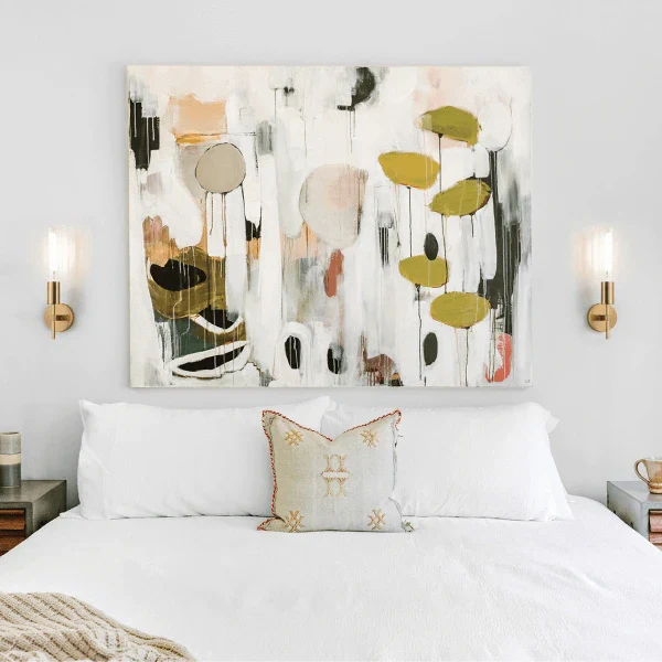 Bedroom with modern wall sconces by Matteo, featuring a cozy and contemporary design with abstract wall art above the bed.