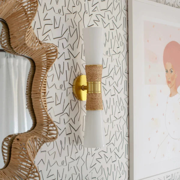 Unique wall sconce by Mitzi with a modern design featuring brass and wrapped details.
