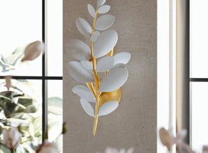 Nature-Inspired lighting with a wall sconce shaped like delicate white leaves and a gold base, bringing organic elegance to the room.