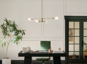 Stylish Office Lighting featuring a modern pendant light over a sleek black desk with a green chair and decorative plant.