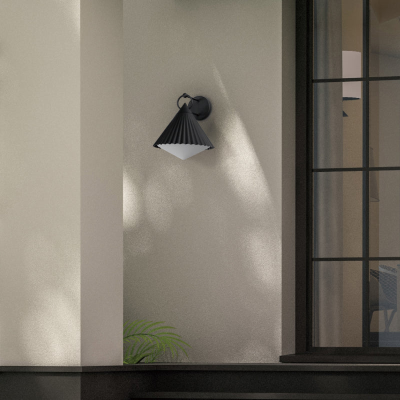 Black Outdoor Wall Lights black pleated outdoor wall light mounted beside a modern window.