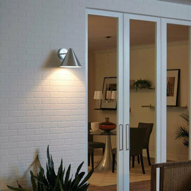 Silver Outdoor Wall Lights silver cone outdoor wall light mounted on a white brick exterior wall.