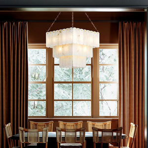 Tiered chandelier with layered rectangular glass panels hanging over a dining table with wicker chairs, available at Lights Canada.