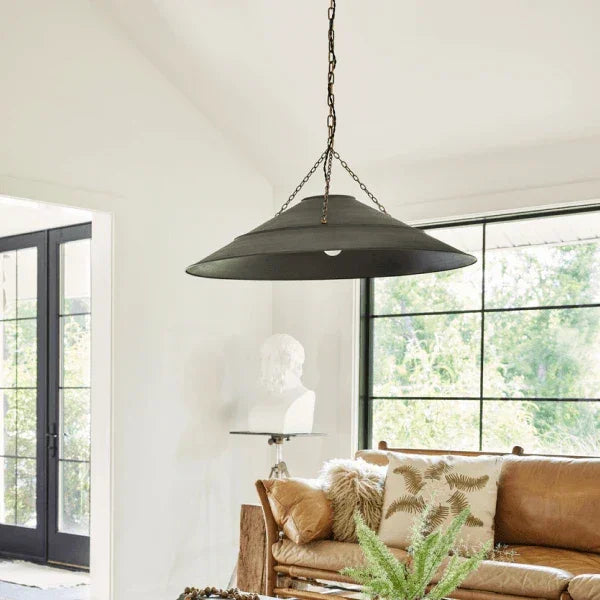 Large black pendant light by Troy hanging in a cozy living room at Lights Canada