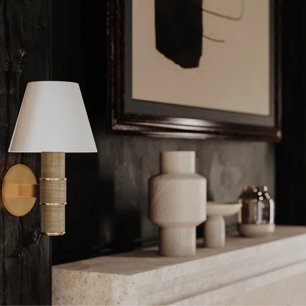 Wall sconce by Troy with a classic design featuring a fabric shade and brass base.