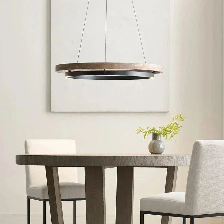 Visual Comfort Modern Collection chandelier with a wooden circular frame hanging over a dining table in a minimalist dining room, available at Lights Canada.