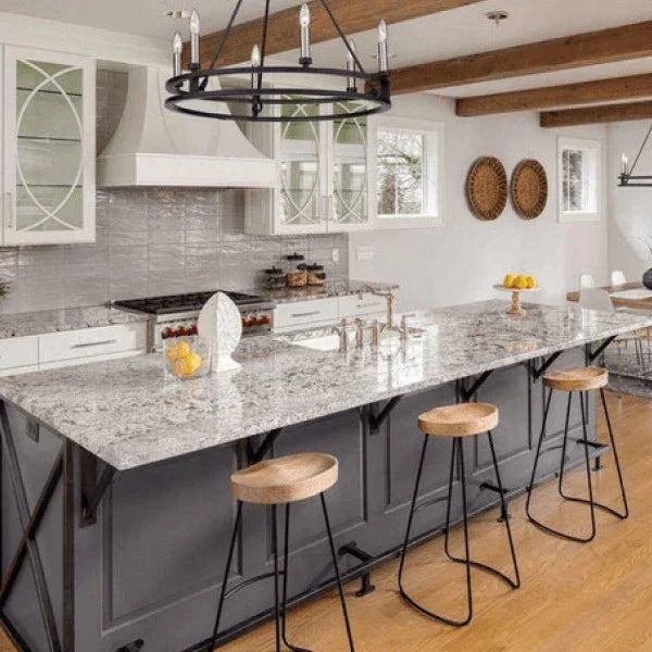 Z-Lite chandelier hanging over a large kitchen island with wooden stools in a bright, modern kitchen, available at Lights Canada.