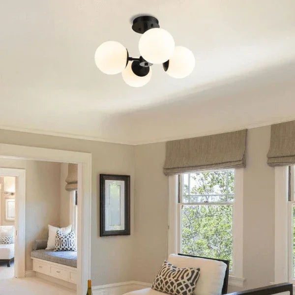 Z-Lite flush mount lighting fixture installed in a cozy room with large windows and neutral decor.
