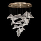 Chandelier with cascading curved textured clear glass panels and a round gold-toned ceiling canopy.
