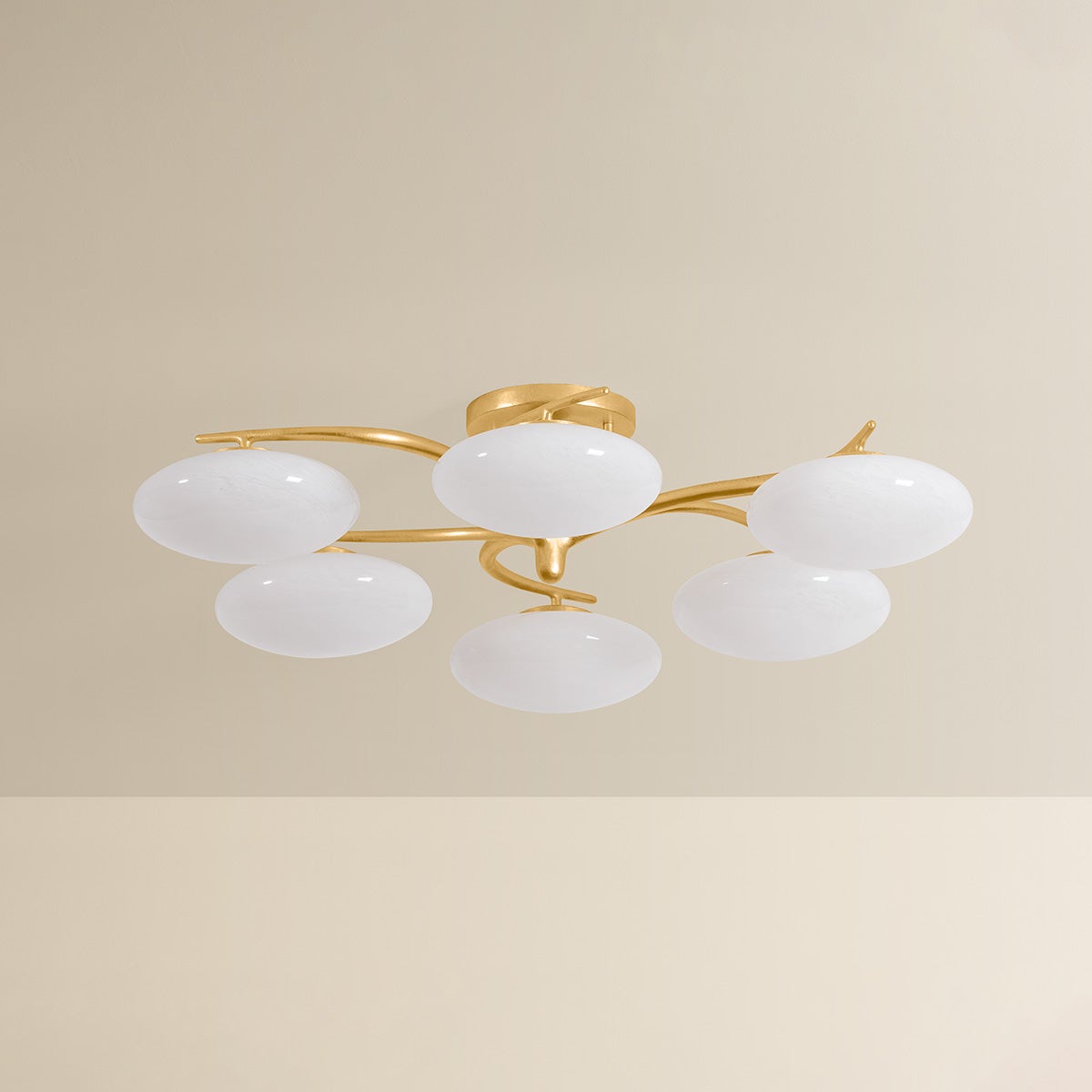 Six-arm chandelier with oval white glass globes on gold brass arms, unlit product shot