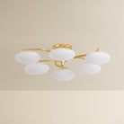 Six-arm chandelier with oval white glass globes on gold brass arms, unlit product shot