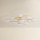 Bayberry multi-arm chandelier with unlit oval white glass globes on gold brass branches, product shot