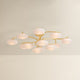 Bayberry multi-arm chandelier with oval white glass globes spreading on gold brass branches, product shot